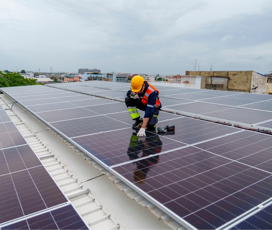 Technician working on rooftop solar panels